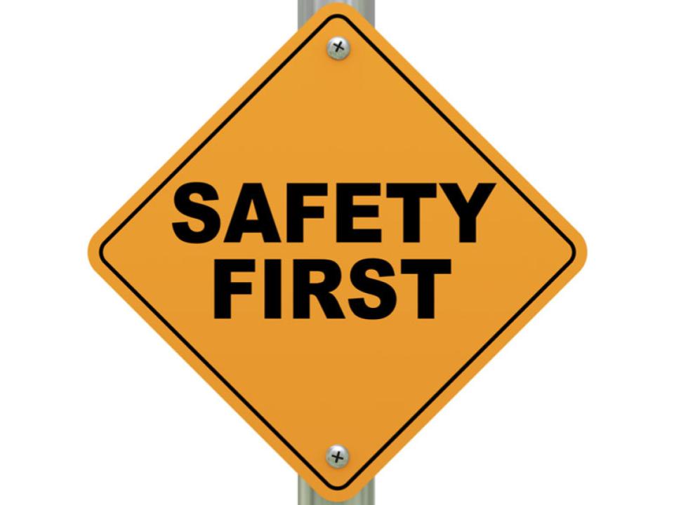 image of a yellow sign with black text that says "Safety First"