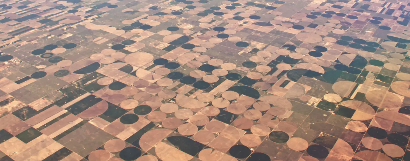 An aerial view of more than twenty circular crop fields of different sizes.