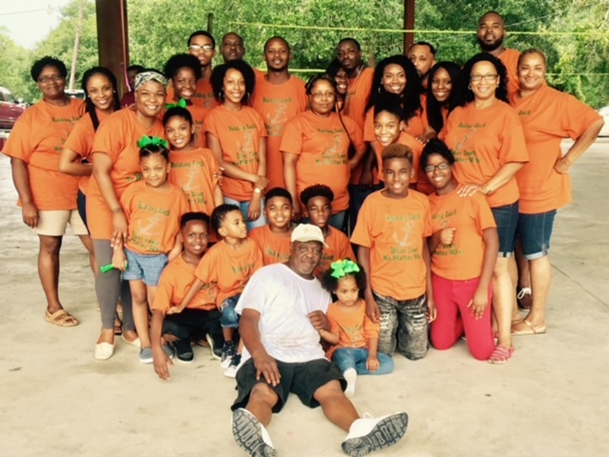 Large happily smiling family at a reunion--all in matching tee shirts