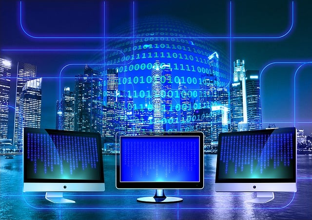 Three computer monitors in in front of a skyline of a city. Binary code is showing in the reflection.
