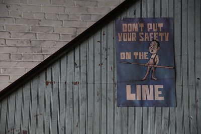 This figure shows a rope walker with no safety harness. The text on the background reads 'Don’t put your safety on the line.’