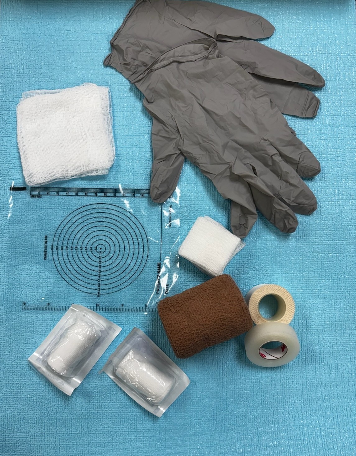 Basic supplies for wound care: tape, gloves, gauze. 