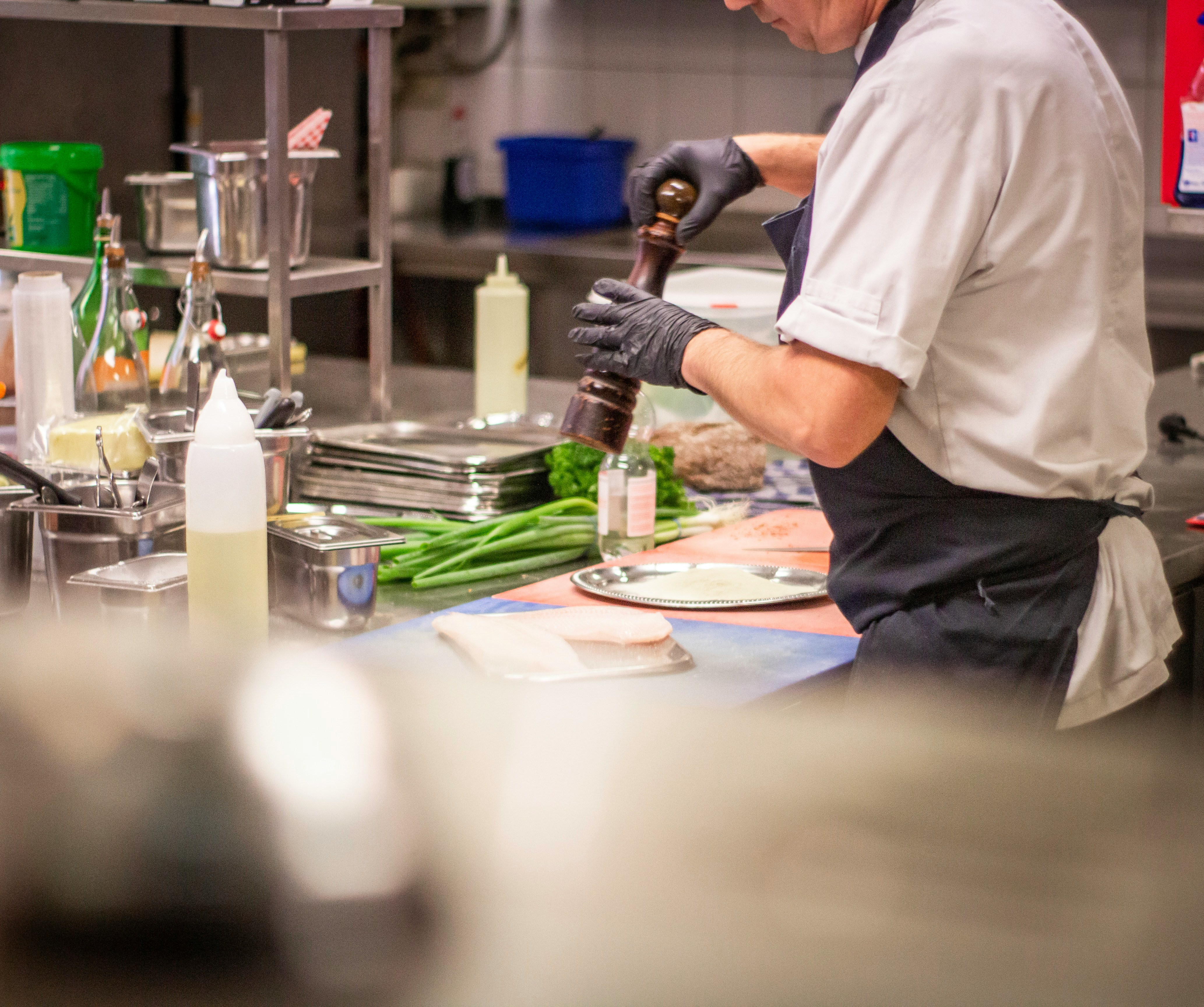 A kitchen employee working with food