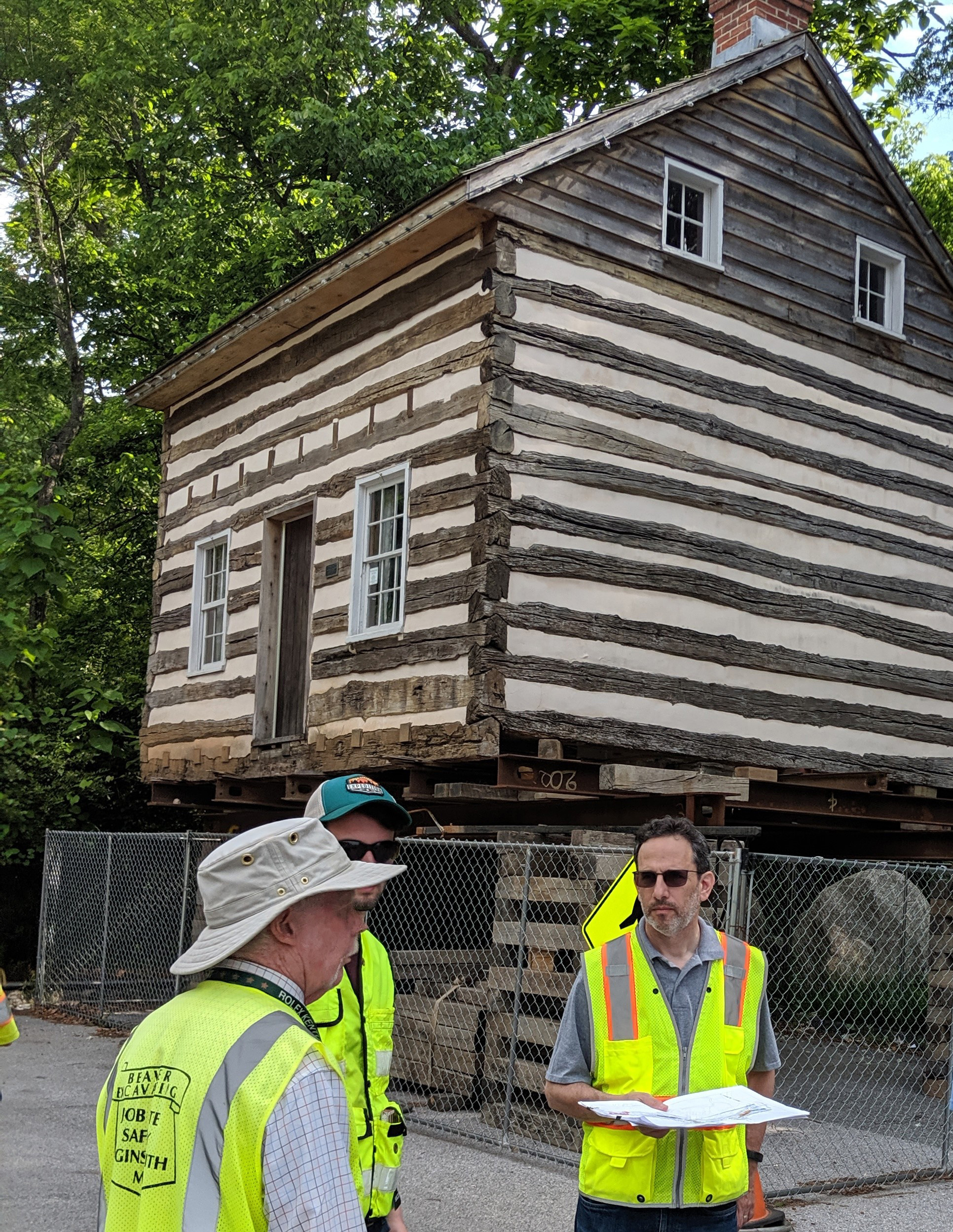 Historic cabin elevated and fenced off